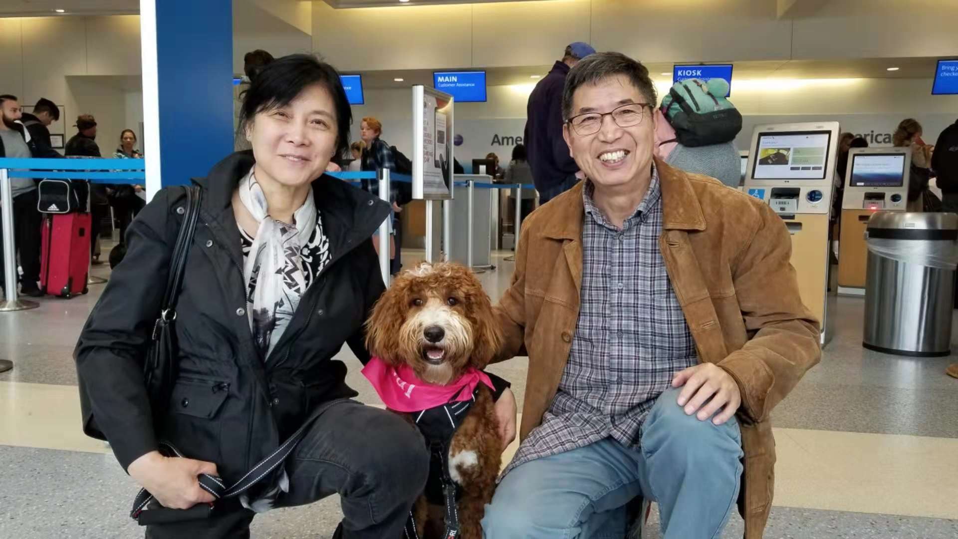 Peanut with Justin's parents at the airport.